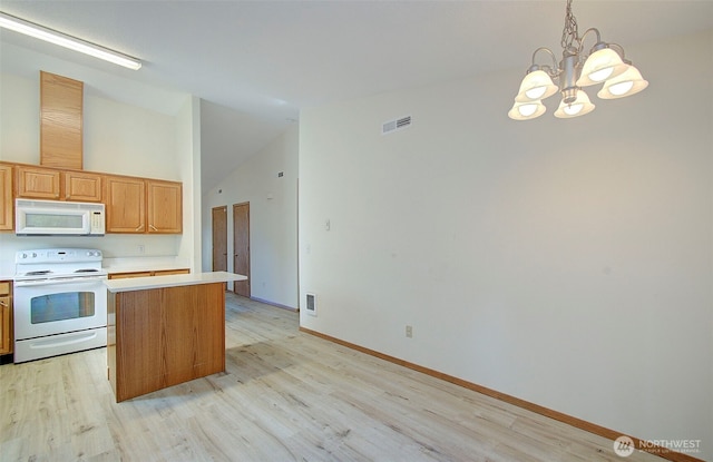 712 SE 5th Way, Battle Ground, WA 98604 - kitchen featuring white appliances, light countertops, light wood-type flooring, a chandelier, and a center island
