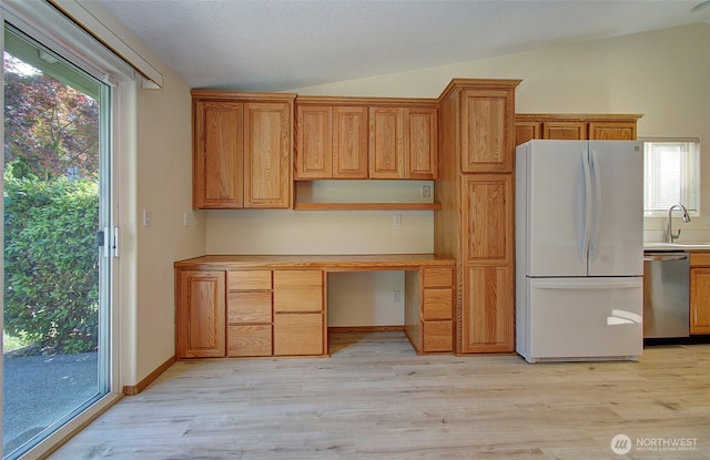 712 SE 5th Way, Battle Ground, WA 98604 - kitchen with freestanding refrigerator, stainless steel dishwasher, vaulted ceiling, open shelves, and light wood-type flooring