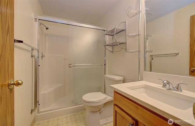 712 SE 5th Way, Battle Ground, WA 98604 - bathroom featuring a shower stall, vanity, toilet, and tile patterned floors