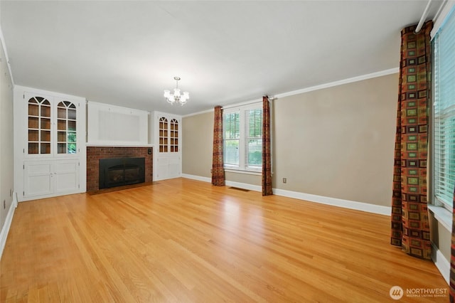 827 Hobson St, Walla Walla, WA 99362 - unfurnished living room featuring baseboards, a chandelier, light wood finished floors, and ornamental molding