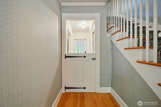 827 Hobson St, Walla Walla, WA 99362 - hallway featuring wood finished floors, baseboards, ornamental molding, stairway, and wallpapered walls