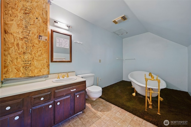 827 Hobson St, Walla Walla, WA 99362 - full bathroom with a soaking tub, vanity, vaulted ceiling, and toilet