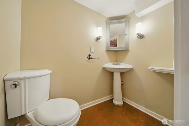827 Hobson St, Walla Walla, WA 99362 - half bathroom with baseboards, finished concrete flooring, toilet, and a sink