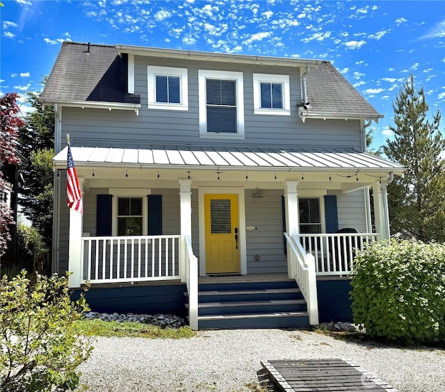 191 Compass St, Pacific Beach, WA 98571 - view of front facade with covered porch, a standing seam roof, a metal roof, and roof with shingles
