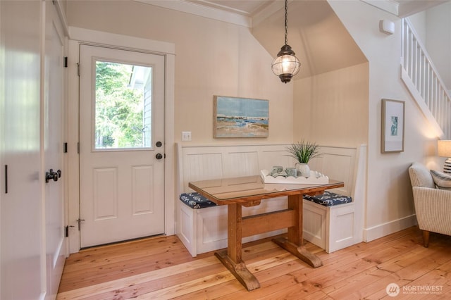 191 Compass St, Pacific Beach, WA 98571 - entryway with ornamental molding, light wood-style floors, a wainscoted wall, and lofted ceiling