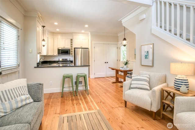 191 Compass St, Pacific Beach, WA 98571 - living area featuring ornamental molding, light wood-style flooring, and recessed lighting