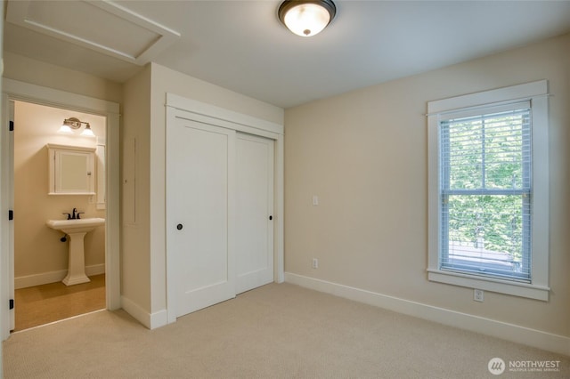 191 Compass St, Pacific Beach, WA 98571 - unfurnished bedroom with light carpet, multiple windows, and attic access