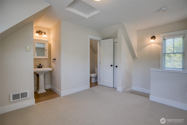 191 Compass St, Pacific Beach, WA 98571 - unfurnished bedroom featuring carpet, connected bathroom, attic access, and vaulted ceiling