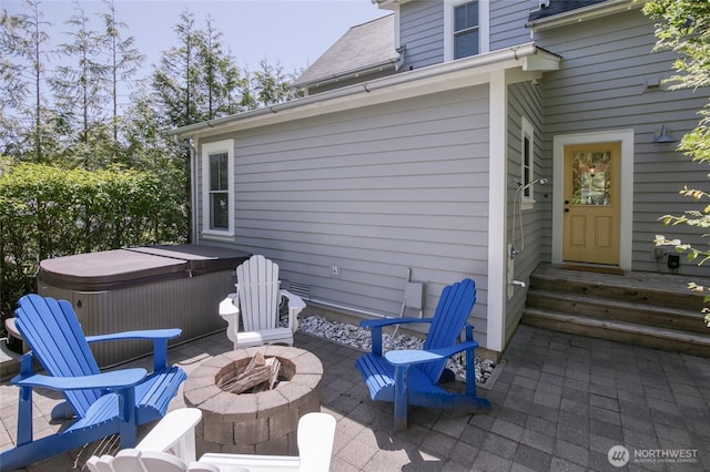 191 Compass St, Pacific Beach, WA 98571 - view of patio / terrace featuring a hot tub and a fire pit