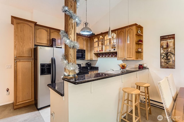 12429 NE 130th Ct NE Unit G304, Kirkland, WA 98034 - kitchen with fridge with ice dispenser, black microwave, a breakfast bar area, a peninsula, and baseboard heating