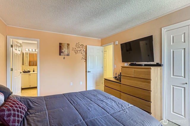 12429 NE 130th Ct NE Unit G304, Kirkland, WA 98034 - bedroom featuring a textured ceiling, ornamental molding, and connected bathroom