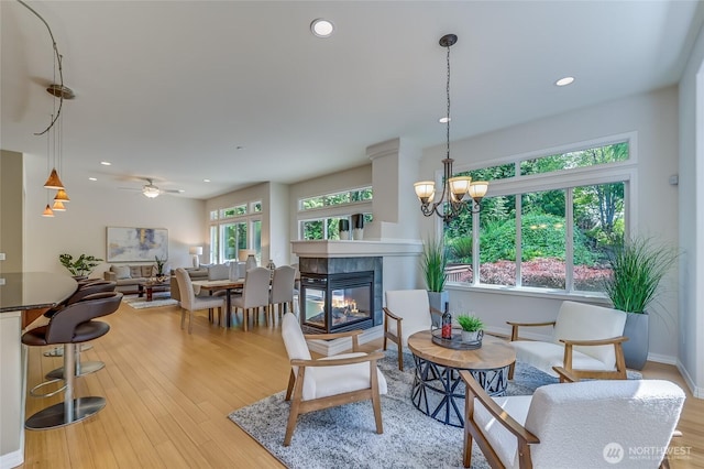 22879 NE 127th Way, Redmond, WA 98053 - living area with a tiled fireplace, ceiling fan, light wood-style flooring, recessed lighting, and baseboards