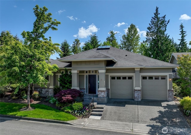 22879 NE 127th Way, Redmond, WA 98053 - view of front facade featuring an attached garage, driveway, roof mounted solar panels, roof with shingles, and brick siding