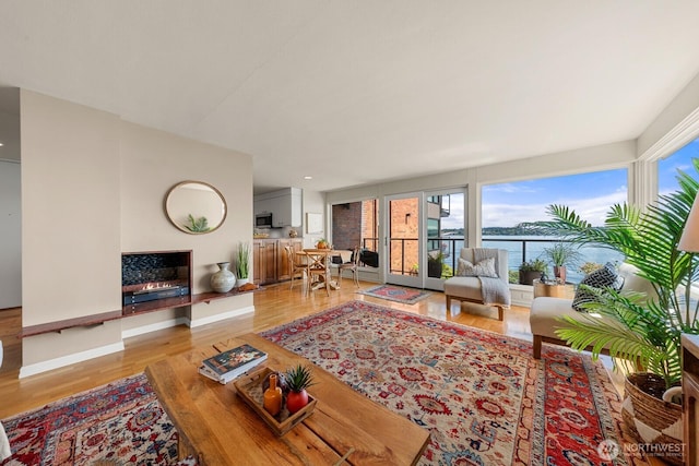 2360 43rd Ave E Unit 213, Seattle, WA 98112 - living room with plenty of natural light, wood finished floors, and a water view