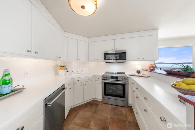 2360 43rd Ave E Unit 213, Seattle, WA 98112 - kitchen featuring stainless steel appliances, white cabinetry, a sink, and light countertops