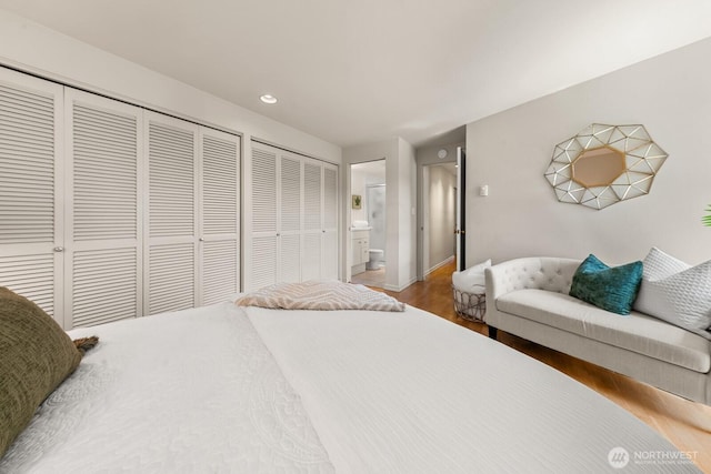 2360 43rd Ave E Unit 213, Seattle, WA 98112 - bedroom with wood finished floors, recessed lighting, ensuite bath, and baseboards