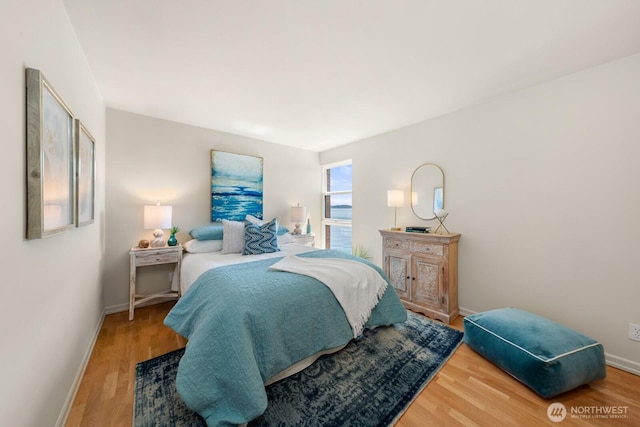 2360 43rd Ave E Unit 213, Seattle, WA 98112 - bedroom featuring wood finished floors and baseboards