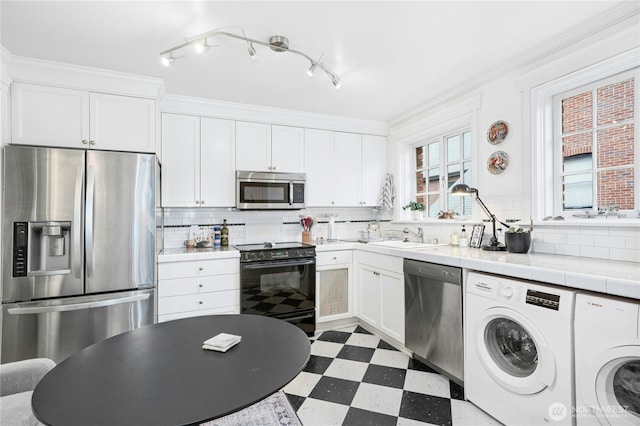 100 W Highland Dr Unit 404, Seattle, WA 98119 - kitchen with appliances with stainless steel finishes, tile patterned floors, tile counters, and white cabinets