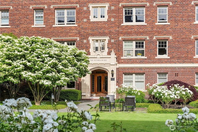 100 W Highland Dr Unit 404, Seattle, WA 98119 - view of front of home with brick siding and a front yard
