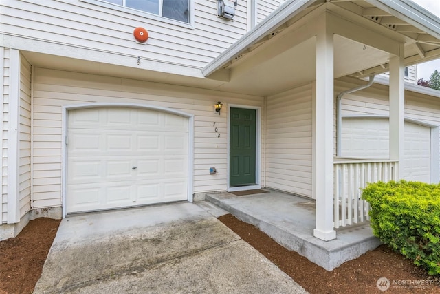 4724 Mill Pond Dr SE Unit 702, Auburn, WA 98092 - property entrance featuring concrete driveway and a garage