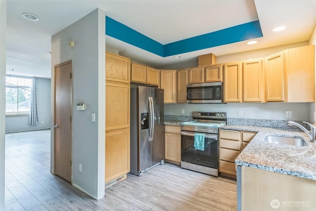 4724 Mill Pond Dr SE Unit 702, Auburn, WA 98092 - kitchen with stainless steel appliances, light brown cabinets, a sink, light stone countertops, and light wood-type flooring