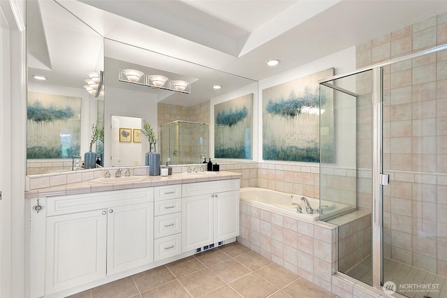 3900 2nd Ave NE Unit 204, Seattle, WA 98105 - full bath featuring tile patterned flooring, double vanity, a shower stall, a garden tub, and recessed lighting