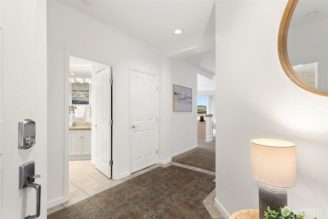 3900 2nd Ave NE Unit 204, Seattle, WA 98105 - hallway featuring baseboards, tile patterned floors, and a sink