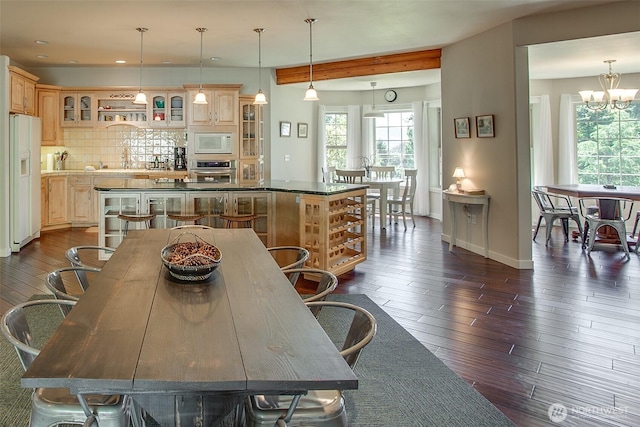 10552 Ski Hill Dr, Leavenworth, WA 98826 - dining space with baseboards, a chandelier, dark wood-style floors, and recessed lighting