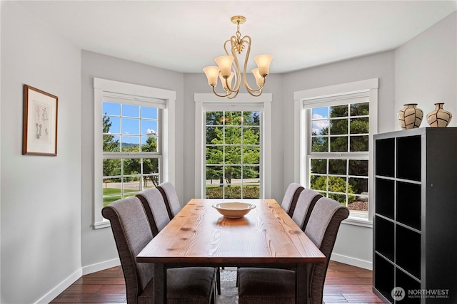 10552 Ski Hill Dr, Leavenworth, WA 98826 - dining space featuring a chandelier, dark wood-style flooring, and healthy amount of natural light