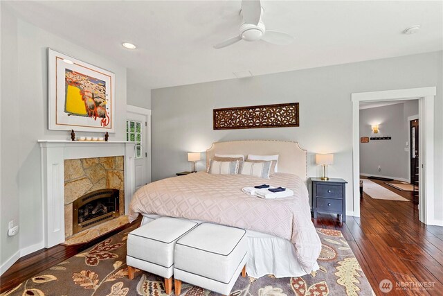 10552 Ski Hill Dr, Leavenworth, WA 98826 - bedroom featuring dark wood finished floors, baseboards, a stone fireplace, and recessed lighting