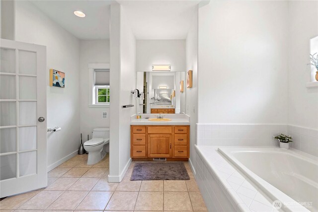 10552 Ski Hill Dr, Leavenworth, WA 98826 - bathroom featuring a garden tub, toilet, vanity, and tile patterned flooring