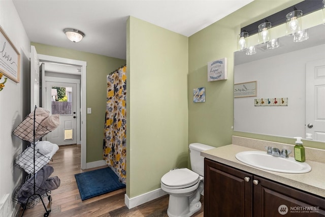 202 Abram Ln, Chehalis, WA 98532 - bathroom featuring wood finished floors, vanity, toilet, baseboards, and curtained shower