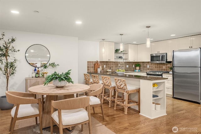 1414 1st Ave W Unit 104, Seattle, WA 98119 - dining space featuring light wood-style flooring and recessed lighting