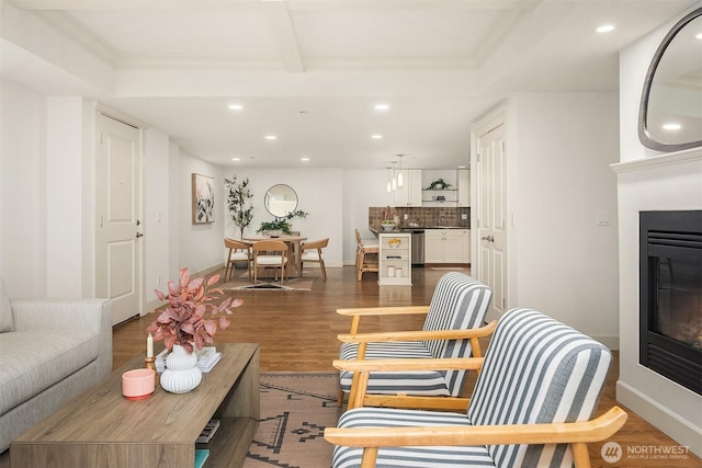 1414 1st Ave W Unit 104, Seattle, WA 98119 - living area featuring recessed lighting, a glass covered fireplace, wood finished floors, and ornamental molding