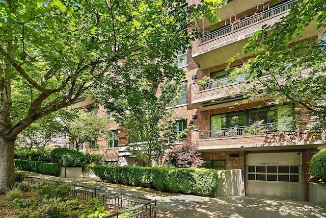 1414 1st Ave W Unit 104, Seattle, WA 98119 - view of building exterior featuring a garage and driveway