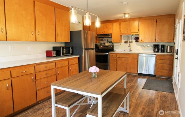 1625 E 61st St, Tacoma, WA 98404 - kitchen featuring stainless steel appliances, under cabinet range hood, and brown cabinets