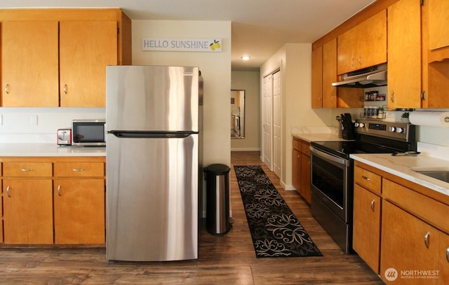 1625 E 61st St, Tacoma, WA 98404 - kitchen with stainless steel appliances, under cabinet range hood, light countertops, and dark wood finished floors