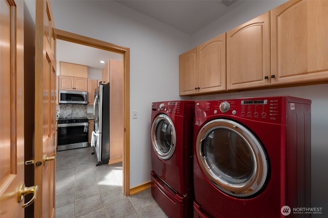 18311 Burn Rd, Arlington, WA 98223 - washroom featuring washer and dryer, cabinet space, light tile patterned floors, and baseboards