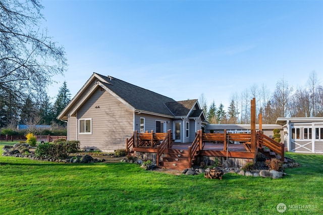 18311 Burn Rd, Arlington, WA 98223 - back of property with a lawn, a wooden deck, and roof with shingles