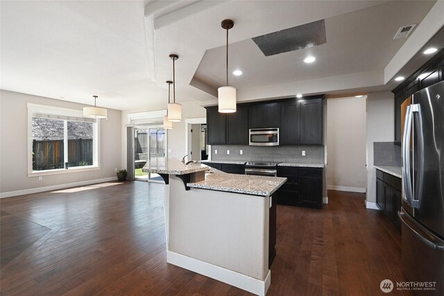 627 68th Ave E, Tacoma, WA 98424 - kitchen with stainless steel appliances, tasteful backsplash, dark cabinetry, and recessed lighting