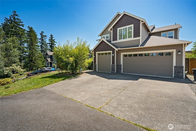 627 68th Ave E, Tacoma, WA 98424 - view of front facade featuring stone siding, driveway, and a garage
