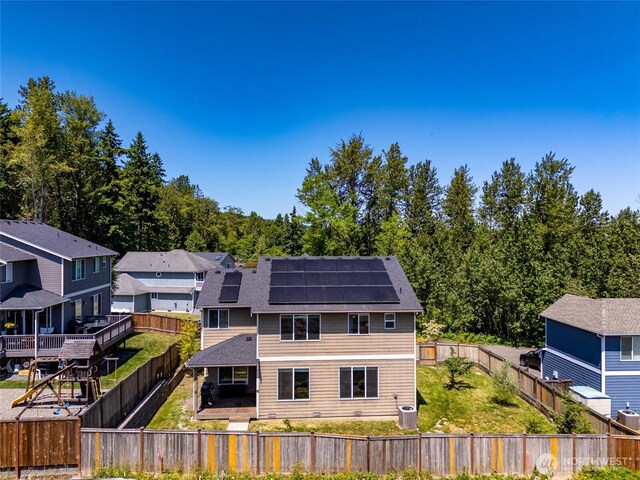 627 68th Ave E, Tacoma, WA 98424 - rear view of property with solar panels, a fenced backyard, and a residential view