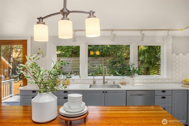4819 S Lucile St, Seattle, WA 98118 - kitchen featuring dishwasher, a sink, gray cabinets, and backsplash