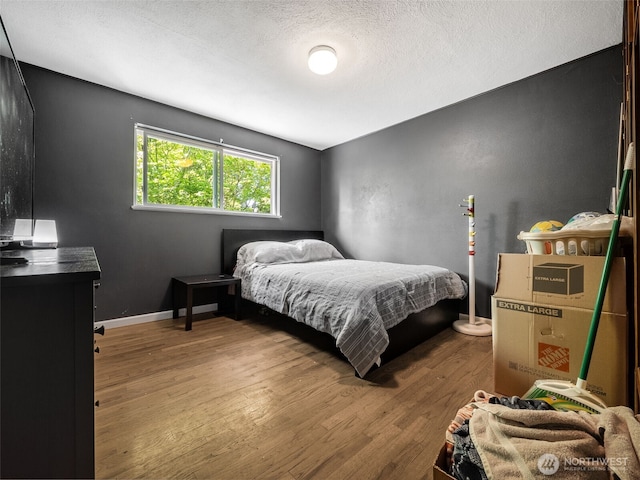 2134 SW 339th St, Federal Way, WA 98023 - bedroom featuring wood finished floors, a textured ceiling, and baseboards