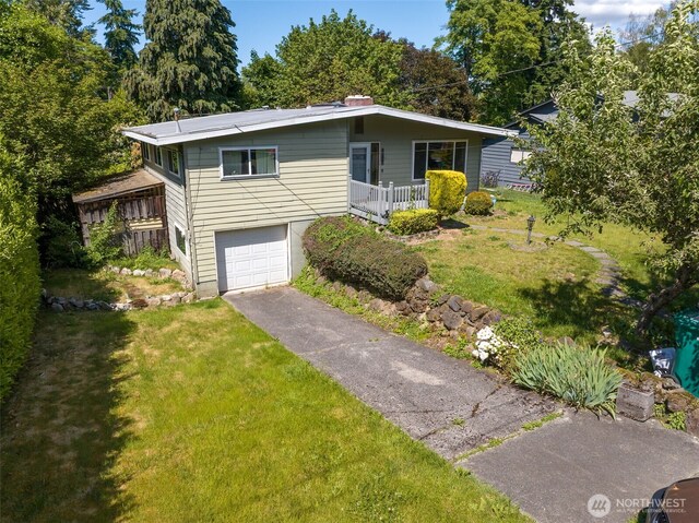2134 SW 339th St, Federal Way, WA 98023 - view of front of house featuring an attached garage, a front lawn, and asphalt driveway