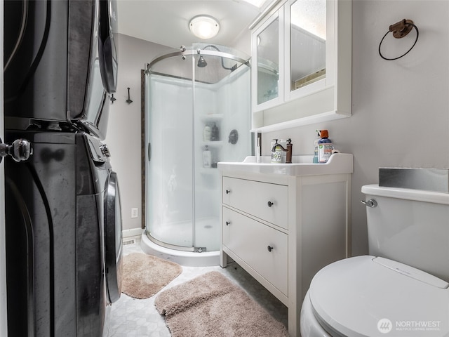 2134 SW 339th St, Federal Way, WA 98023 - bathroom featuring a shower stall, toilet, estacked washer and dryer, and vanity
