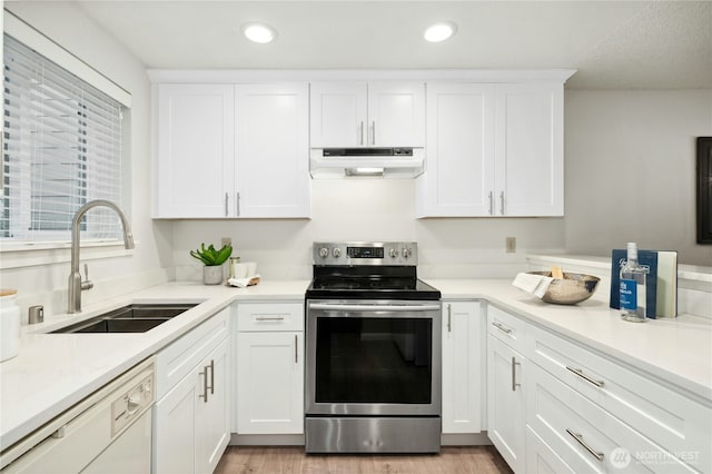 12721 NE 116th St Unit F102, Kirkland, WA 98034 - kitchen featuring under cabinet range hood, stainless steel electric range, a sink, dishwasher, and recessed lighting