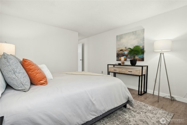 12721 NE 116th St Unit F102, Kirkland, WA 98034 - bedroom with wood finished floors and baseboards