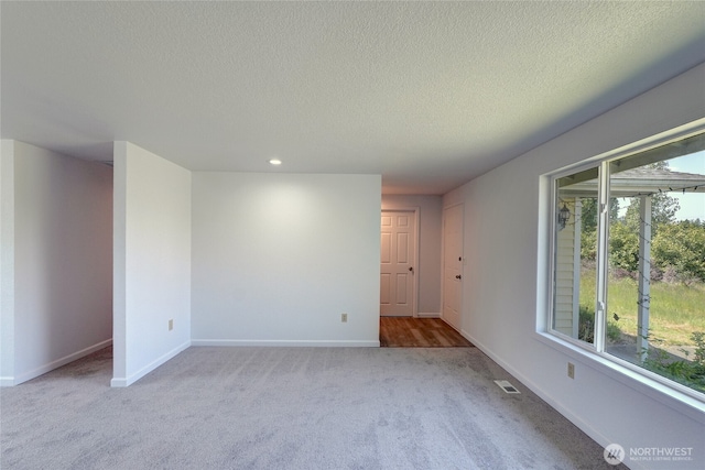 2320 183rd Street Ct E, Tacoma, WA 98445 - unfurnished room featuring light colored carpet, baseboards, plenty of natural light, a textured ceiling, and recessed lighting