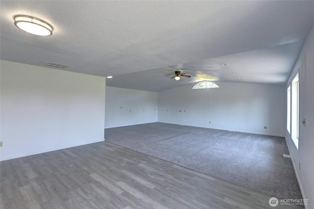 2320 183rd Street Ct E, Tacoma, WA 98445 - carpeted empty room featuring a ceiling fan, wood finished floors, lofted ceiling, and a textured ceiling